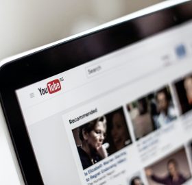 View of a YouTube homepage with videos on the laptop screen.