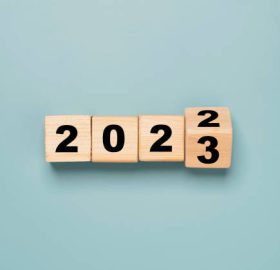 Wooden block cube flipping between 2022 to 2023.
