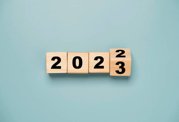 Wooden block cube flipping between 2022 to 2023.