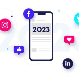 Bubbles floating around iphone that says 2023. Bubbles include Instagram logo, like, Facebook logo, Twitter blue bird logo, heart, and LinkedIn logo.