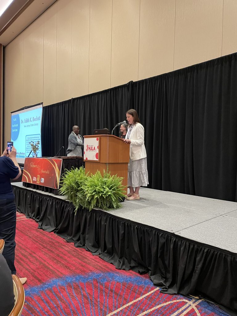 Dr. Edith Beckett receiving NJAL Technical Services Award on stage at NJLA.
