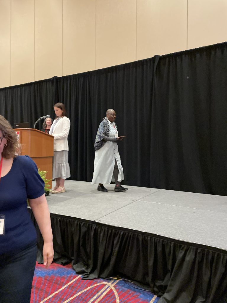 Dr. Edith Beckett receiving NJAL Technical Services Award on stage at NJLA.