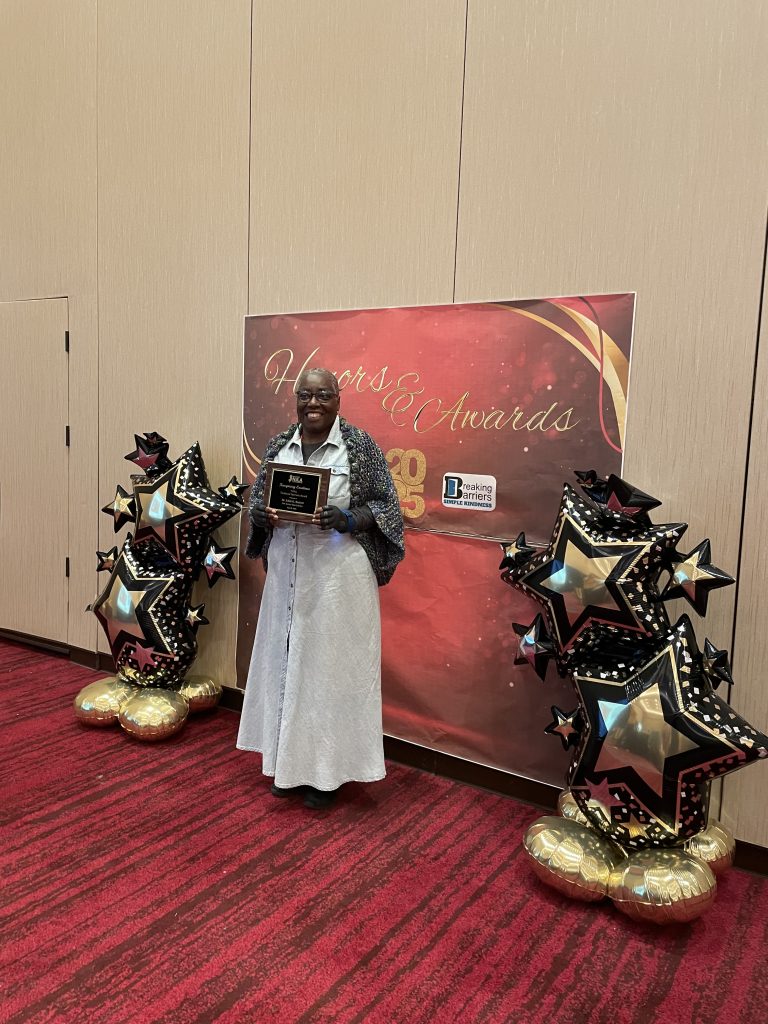 Dr. Edith Beckett with the NJAL Technical Services Award at NJLA, posing for a photo.