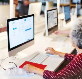 Seniors using computers in a library.