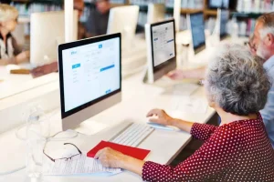 Seniors using computers in a library.